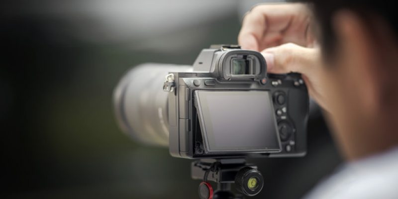 The photographer taking a photo with digital camera